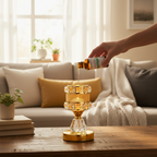 Bird of Paradise fragrance oil bottle being poured into Designer Gold warmer in cozy living room