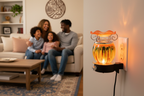 Orange tie dye ball wall burner plugged into wall with family scene and prayer plaque